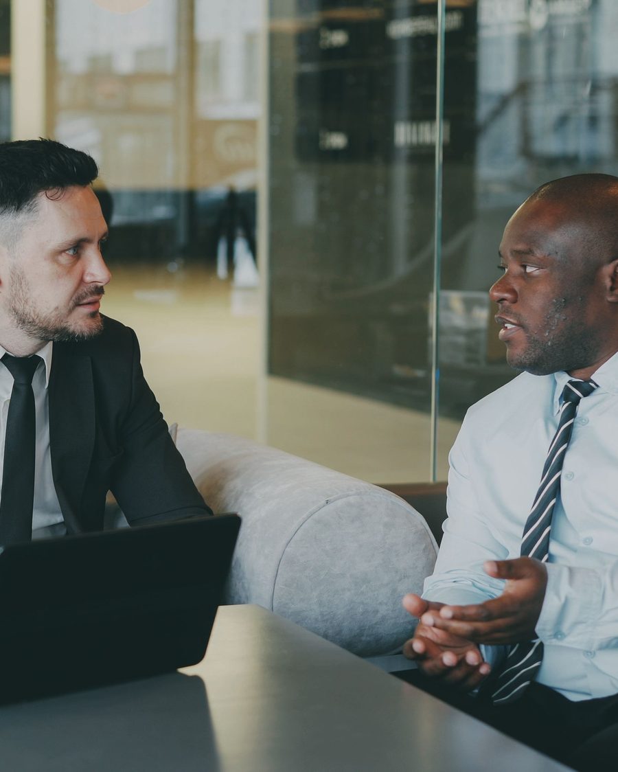 Two advisors in discussion at a client meeting